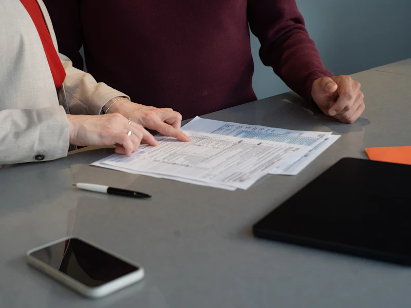 Two people reviewing documents during a consultation